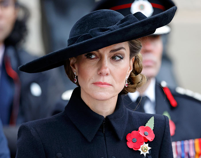 Princess Kate wearing a black hat and coat with poppy flowers during a public event amid BBC headline backlash.