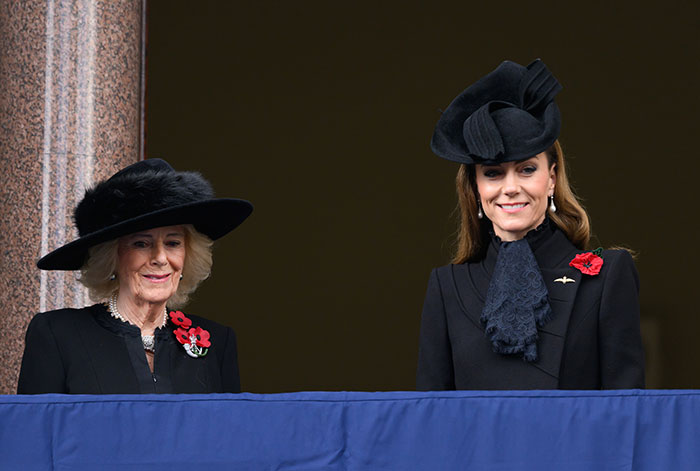 Princess Kate and Camilla wearing black hats and coats, attending a formal event with poppy pins visible.