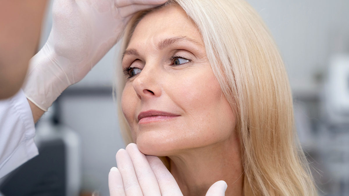 Middle-aged woman consulting a cosmetic surgeon about facial surgery reflecting desire and concern in a clinical setting