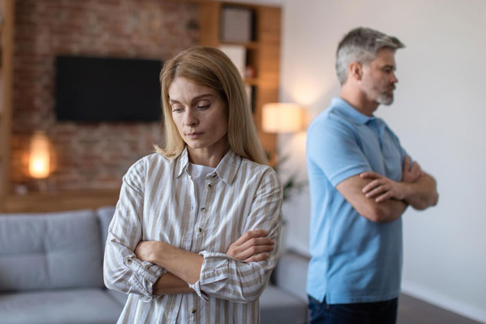 Woman refusing to pay for dad’s lovechild’s surgery with inheritance money, dad looks upset in home setting.