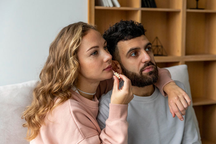 Young siblings sitting closely on a couch, showing emotional connection after years of family silence and abandonment. Young siblings sitting closely on a couch, showing emotional connection after years of family silence and abandonment.