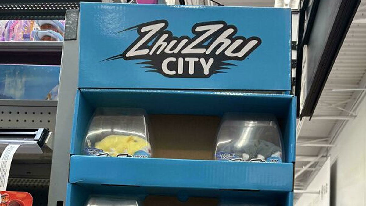 Toy display of ZhuZhu City in a retail store aisle during Black Friday shopping rush with some empty shelves visible.
