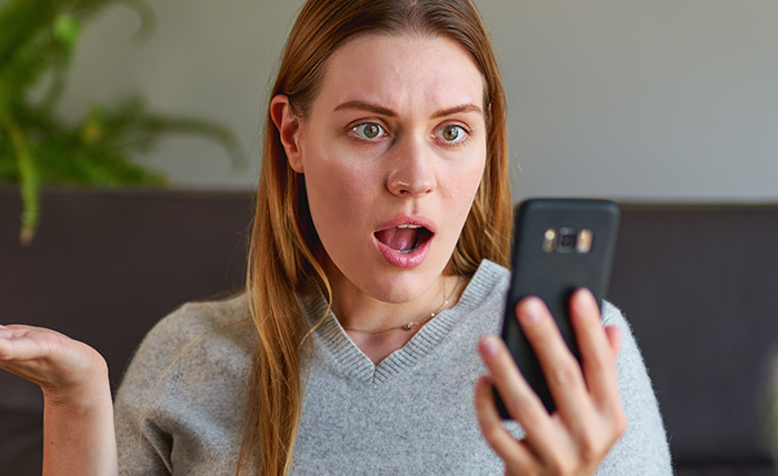 Shocked woman reading phone message about partner cheating during pregnancy and postpartum, expressing disbelief at betrayal. Shocked woman reading phone message about partner cheating during pregnancy and postpartum, expressing disbelief at betrayal.