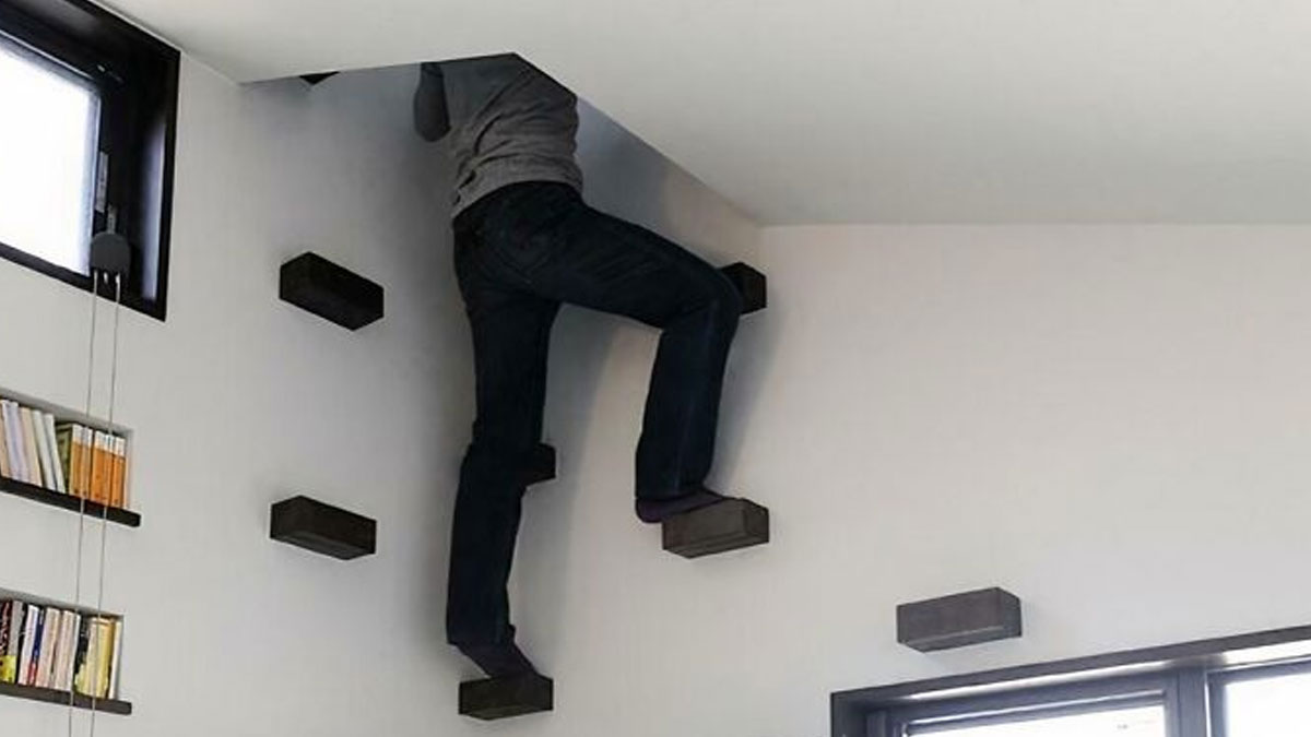 Person climbing unusual floating stairs attached to vertical wall in an Airbnb rental emphasizing need for insurance.