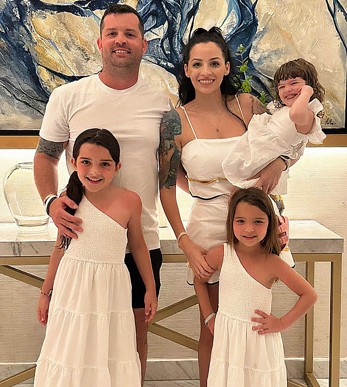 Family portrait with dad and children, highlighting chilling details after dad left 2YO in car during adult video binge. Family portrait with dad and children, highlighting chilling details after dad left 2YO in car during adult video binge.