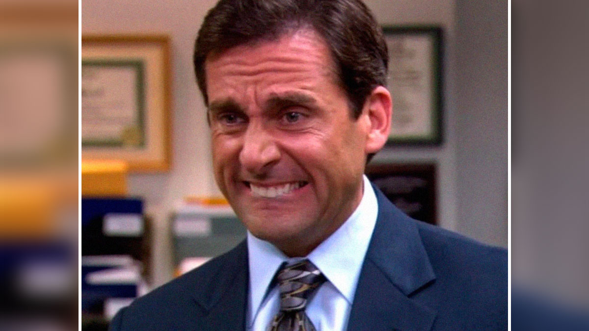 Man in office suit making a tense face, perfectly capturing the feeling of self-deprecating memes feel personally attacked.