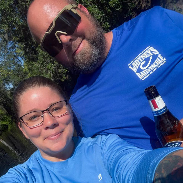 Man and woman outdoors, man wearing sunglasses and holding beer, related to father of teen slain affair with babysitter news. Man and woman outdoors, man wearing sunglasses and holding beer, related to father of teen slain affair with babysitter news.