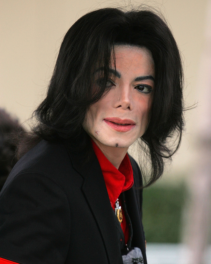 Michael Jackson in a black jacket and red shirt, captured during public appearance amid disturbing new allegations. Michael Jackson in a black jacket and red shirt, captured during public appearance amid disturbing new allegations.