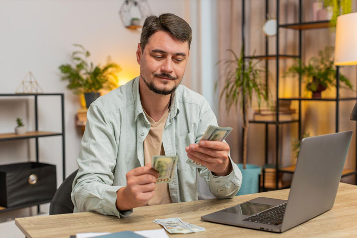 Man counting money at home, illustrating the concept of asking husband for money when sick and in need of support. Man counting money at home, illustrating the concept of asking husband for money when sick and in need of support.