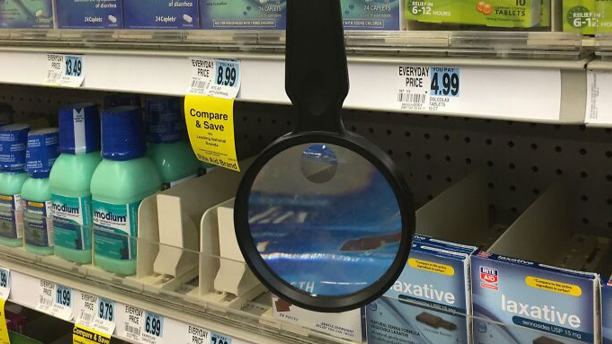 Magnifying glass attached to store shelf enhancing product labels, a smart idea and invention solving shopping visibility problems.
