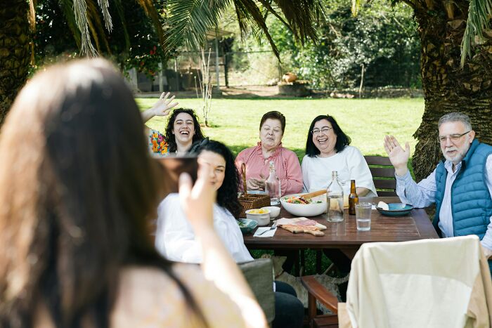 Family visit at outdoor table with smiling relatives, highlighting teen’s sprain and c*****d ribs accident discovery. Family visit at outdoor table with smiling relatives, highlighting teen’s sprain and c*****d ribs accident discovery.