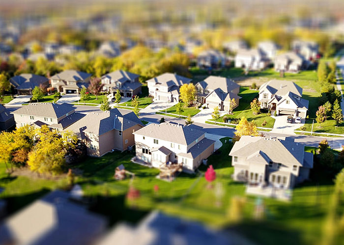 A suburban neighborhood of houses representing a community with an HOA president involved in a court case. A suburban neighborhood of houses representing a community with an HOA president involved in a court case.