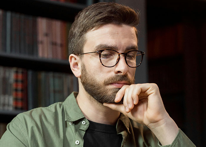 Man with glasses and beard, deep in thought while uncovering HOA president secrets for court resolution. Man with glasses and beard, deep in thought while uncovering HOA president secrets for court resolution.