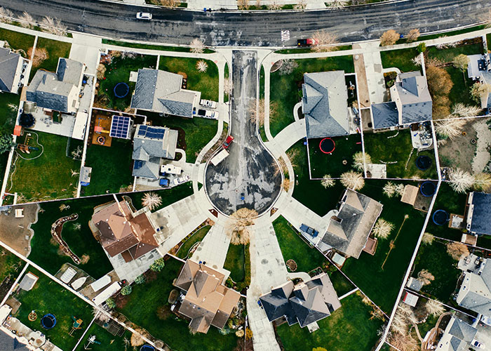 Aerial view of suburban neighborhood cul-de-sac illustrating HOA community setting for HOA president conflict. Aerial view of suburban neighborhood cul-de-sac illustrating HOA community setting for HOA president conflict.