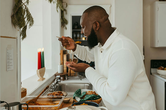 Grieving dad preparing birthday meal for daughter in cozy kitchen, showing love despite financial challenges.