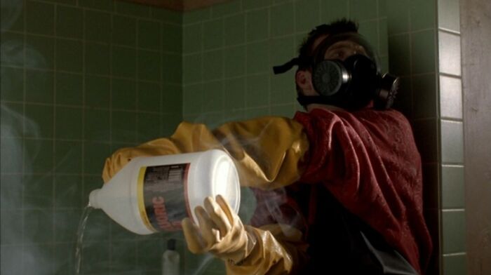 Person in protective gear pouring chemical in a smoky room, illustrating strange facts about our world’s unusual moments.