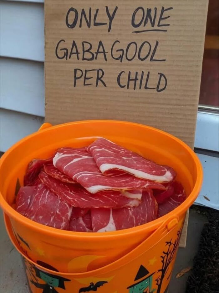 Orange bucket filled with slices of gabagool meat with a sign limiting one gabagool per child as a stupid food meme.