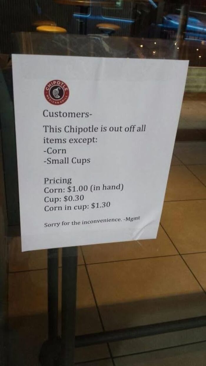 Funny Chipotle sign showing corn and cup prices, highlighting humor in stupid food memes for stupid people.