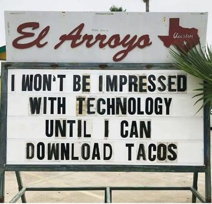 Humorous restaurant sign about technology and tacos, a classic stupid food meme to ruin your appetite.