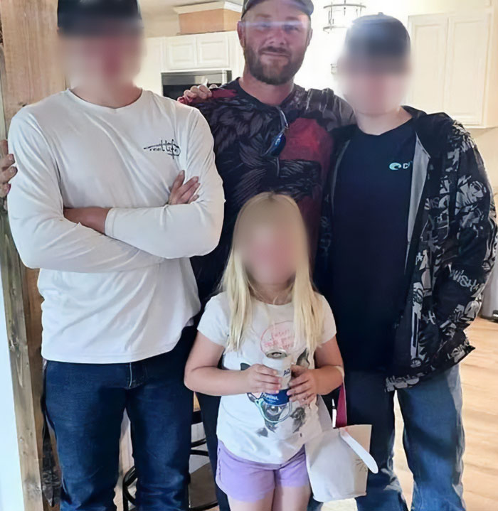 Man with three children standing indoors, related to father of teen slain on cruise and babysitter affair news. Man with three children standing indoors, related to father of teen slain on cruise and babysitter affair news.
