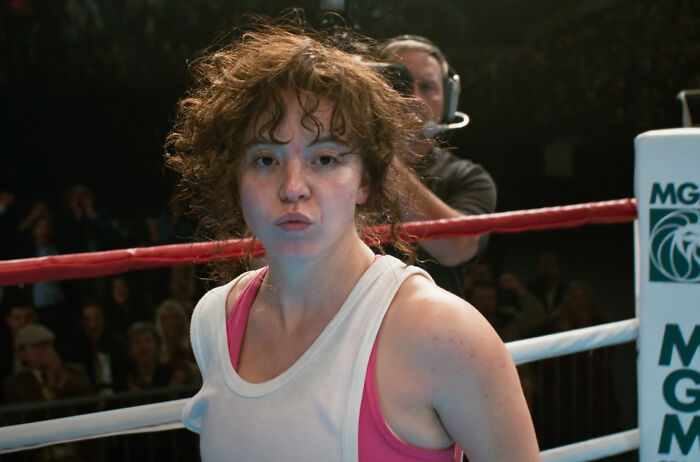 Sydney Sweeney in a boxing ring scene with curly hair, wearing a white tank top, highlighting PR damage control after Christy flops.