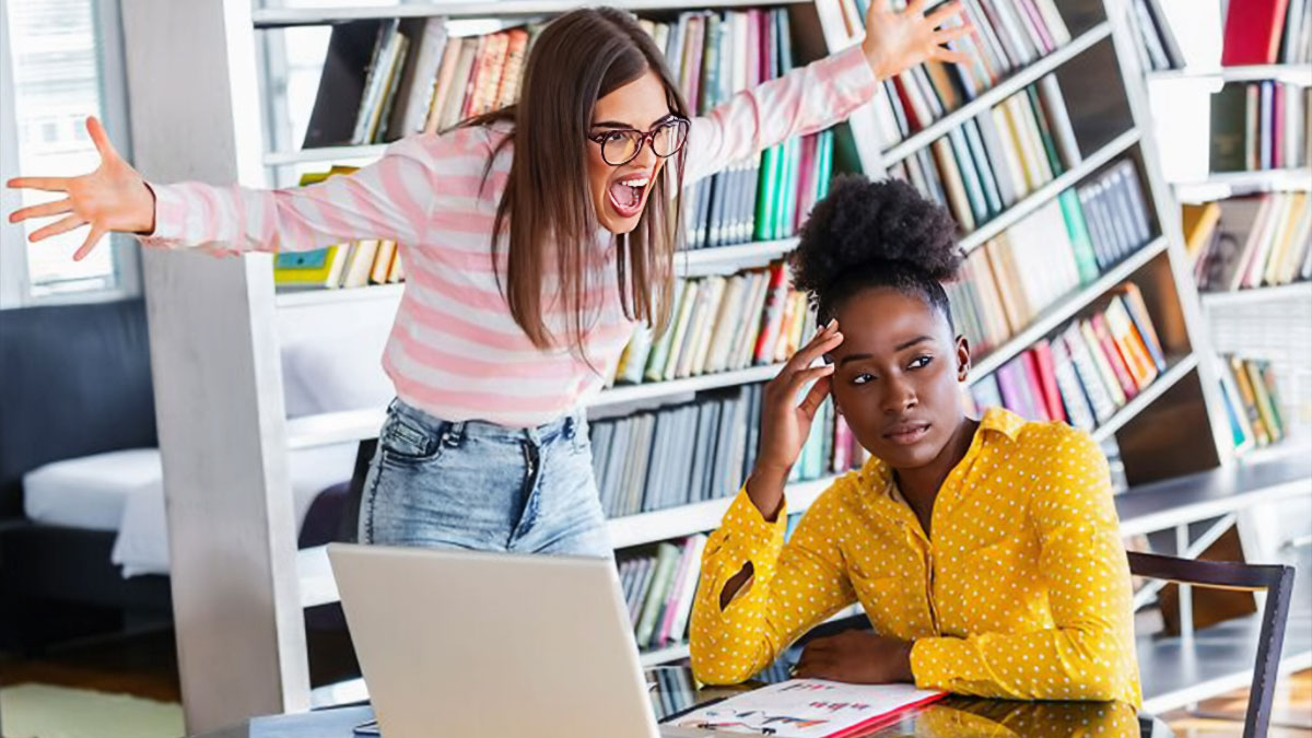 Two women displaying toxic relationship traits with one angrily yelling and the other looking upset in a library setting.