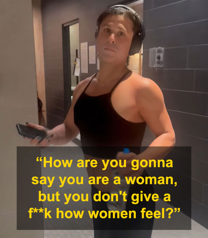 Person in gym wearing headphones and a black tank top holding phone, related to uproar over lesbian confronting alleged trans woman. Person in gym wearing headphones and a black tank top holding phone, related to uproar over lesbian confronting alleged trans woman.
