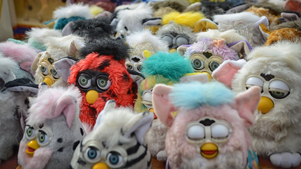 A collection of vintage Furby toys with haunting eyes, evoking eerie feelings related to truckers' nighttime road experiences.