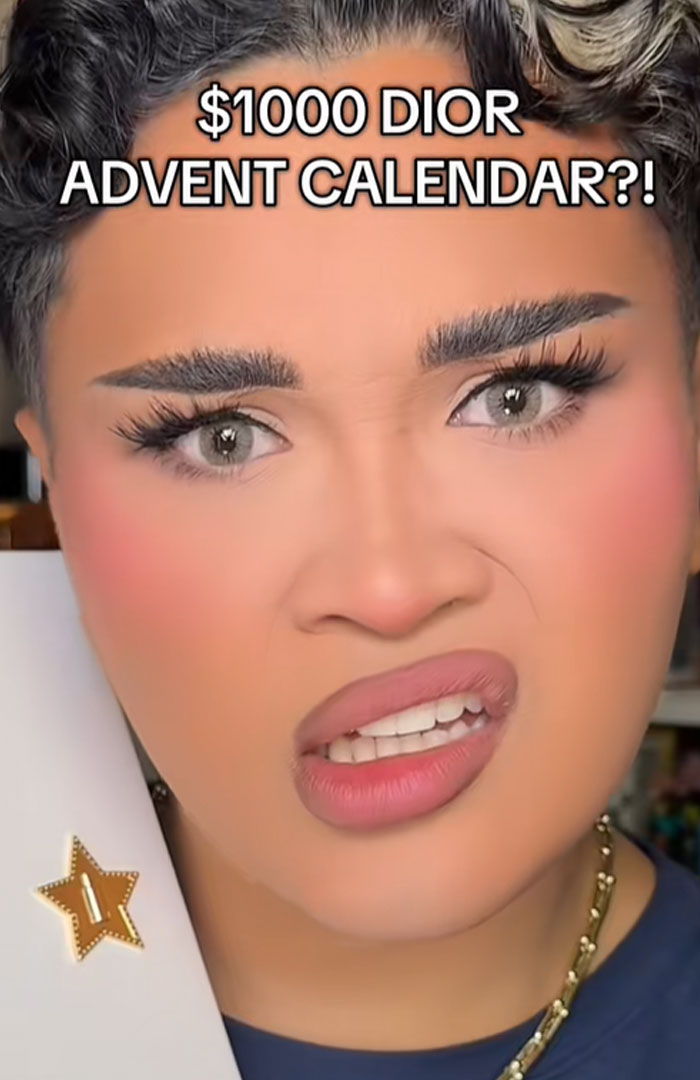 Person making a confused face holding a $1000 Dior advent calendar, reacting to its high price and value debated online. Person making a confused face holding a $1000 Dior advent calendar, reacting to its high price and value debated online.