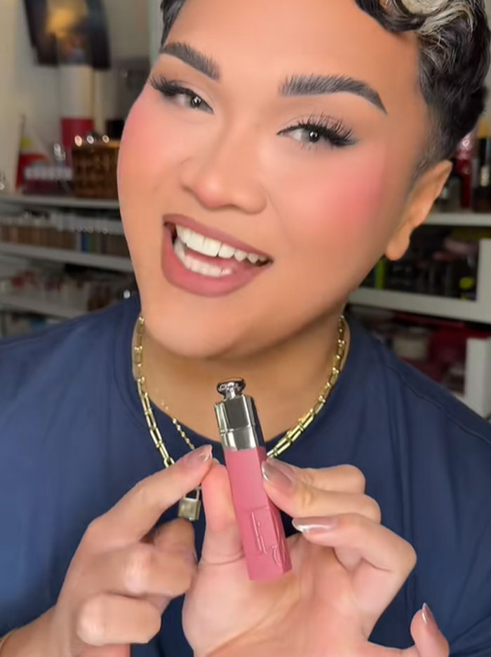 Person holding a Dior lip product, discussing the luxury advent calendar and people's reactions to its price. Person holding a Dior lip product, discussing the luxury advent calendar and people's reactions to its price.