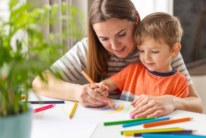 Mother and child drawing together at a table, showing loving support in parenting despite ungrateful husband challenges. Mother and child drawing together at a table, showing loving support in parenting despite ungrateful husband challenges.