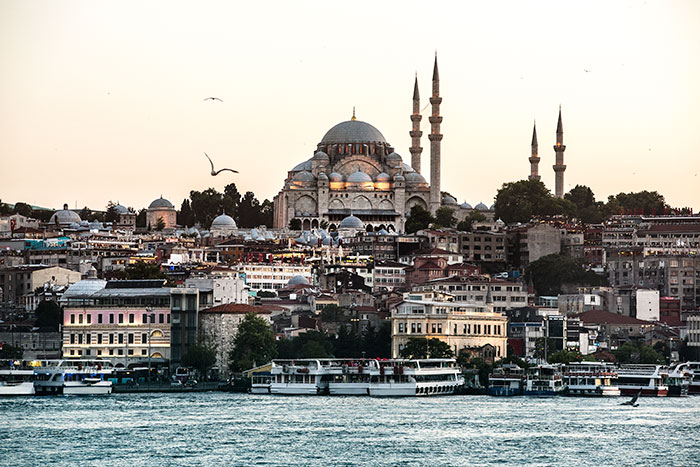Istanbul cityscape at sunset with boats on water, highlighting places solo female travelers do not recommend.