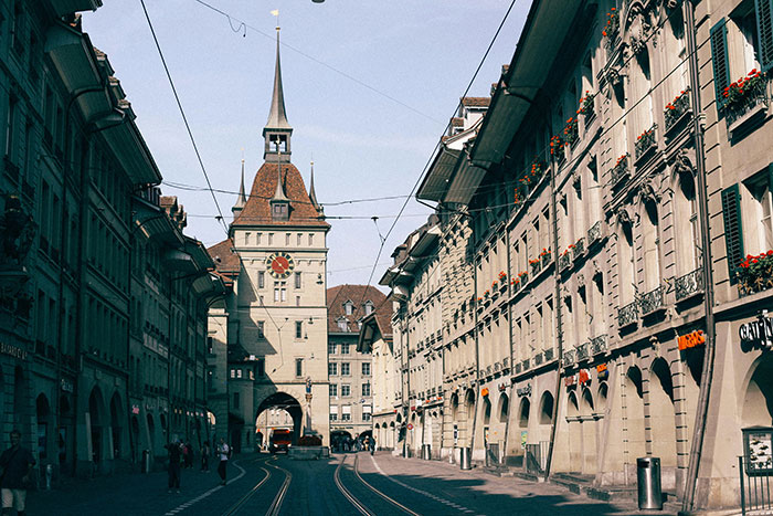 Historic European street with clock tower, emphasizing solo female travelers and places not recommended for safety concerns.