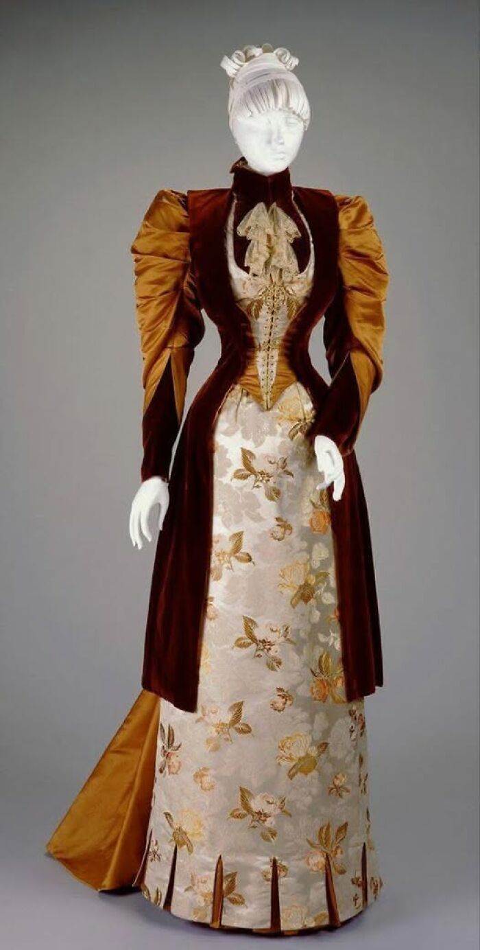 Victorian-Edwardian pictures of a mannequin dressed in a brown and gold floral ornate vintage gown and puffed sleeves.