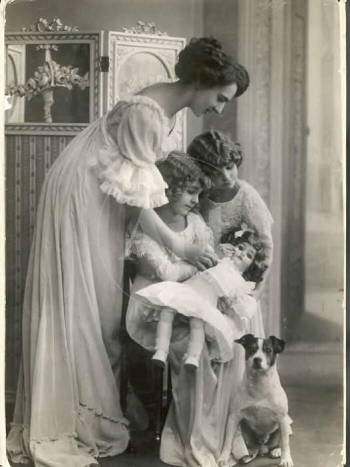 Victorian-Edwardian pictures showing women and children in period dress with a dog in a vintage indoor setting.
