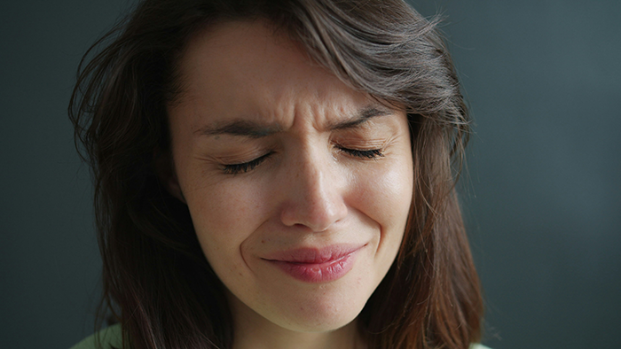 Close-up of a distressed woman fighting for her life in hospital, showing emotional pain and struggle indoors. Close-up of a distressed woman fighting for her life in hospital, showing emotional pain and struggle indoors.