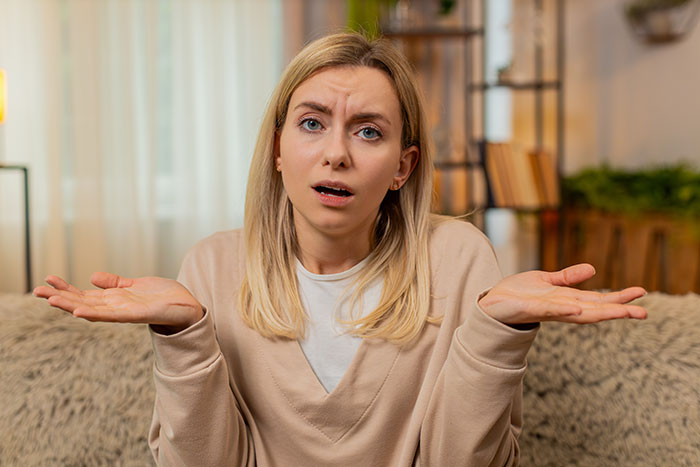 Woman looking confused and frustrated at home, representing an avid walker dealing with criticism from family. Woman looking confused and frustrated at home, representing an avid walker dealing with criticism from family.
