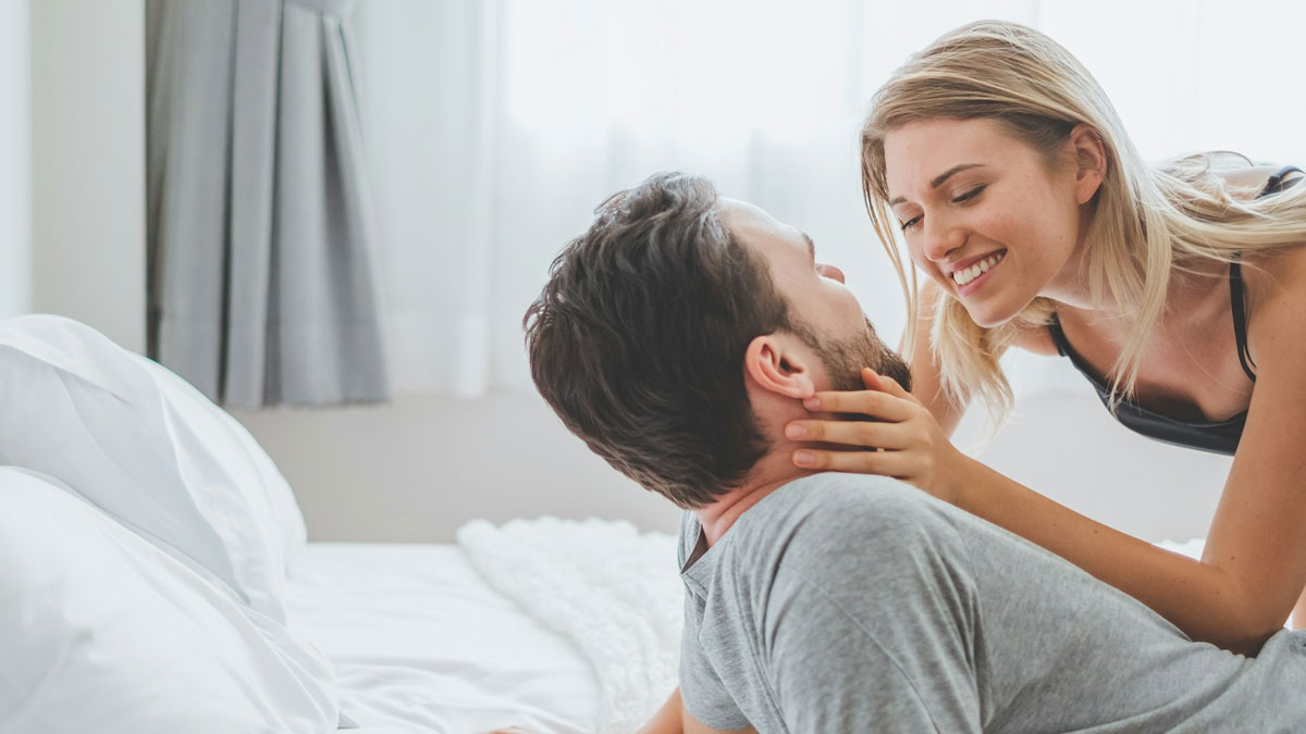 Couple sharing an intimate moment on bed illustrating uniquely awkward weddings that crashed and burned before happening