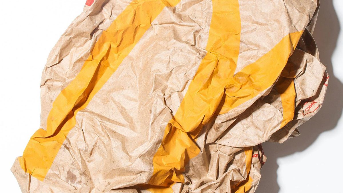 Crumpled vintage paper bag found among fascinating items people discovered in the walls of their homes.