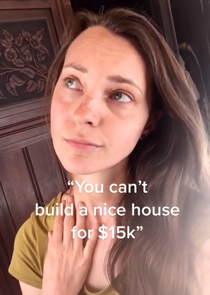 Young woman with long hair indoors, expressing concern about building a $15K cabin in the woods safety debate. Young woman with long hair indoors, expressing concern about building a $15K cabin in the woods safety debate.