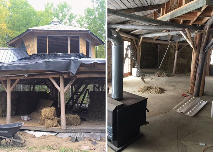 Rustic cabin under construction in the woods with exposed wooden beams and hay bales raising safety concerns.