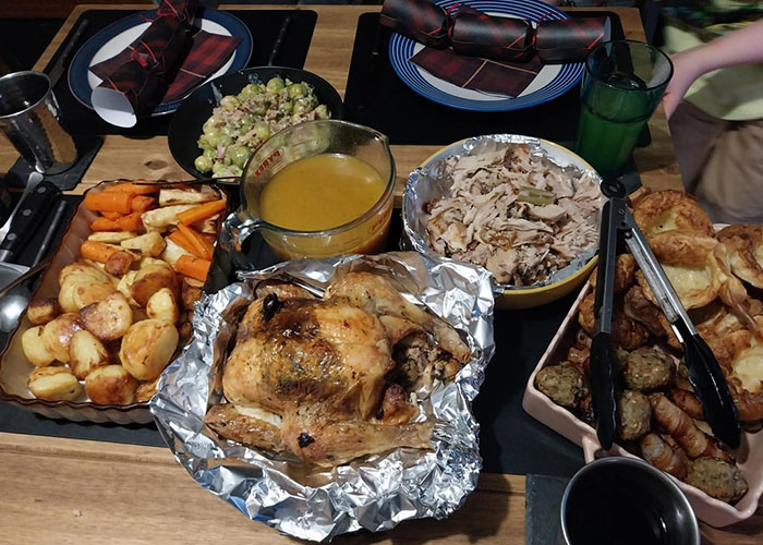 Traditional Christmas spread with roasted chicken, vegetables, stuffing, and gravy, highlighting foreign holiday cuisine elements. Traditional Christmas spread with roasted chicken, vegetables, stuffing, and gravy, highlighting foreign holiday cuisine elements.