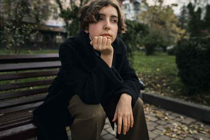Person sitting on a bench outdoors, looking moody and contemplative, reflecting the theme of wife preparing feast and fun. Person sitting on a bench outdoors, looking moody and contemplative, reflecting the theme of wife preparing feast and fun.