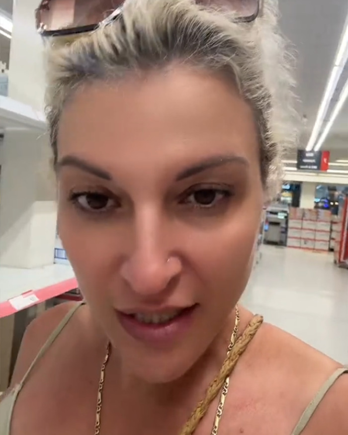 Woman speaking in a store about decency in public and the viral rant on gross activewear trends dividing opinions online. Woman speaking in a store about decency in public and the viral rant on gross activewear trends dividing opinions online.