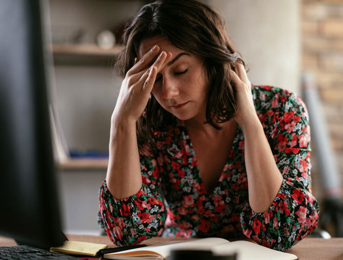 Woman feeling stressed and overwhelmed while asking for a break from hosting a traditional family Thanksgiving. Woman feeling stressed and overwhelmed while asking for a break from hosting a traditional family Thanksgiving.