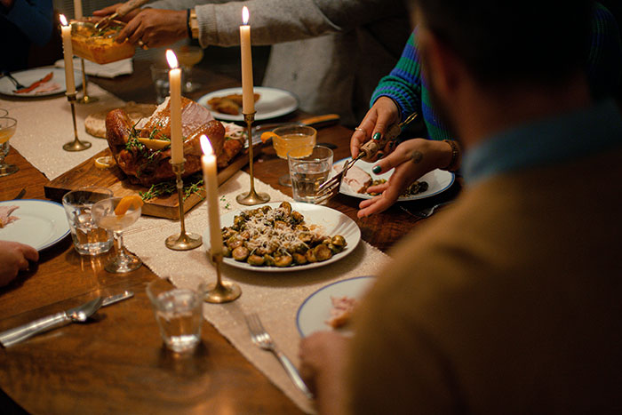 Family gathered for Thanksgiving dinner with a turkey and candles, tensions rising over stepdaughter’s sexuality comments. Family gathered for Thanksgiving dinner with a turkey and candles, tensions rising over stepdaughter’s sexuality comments.