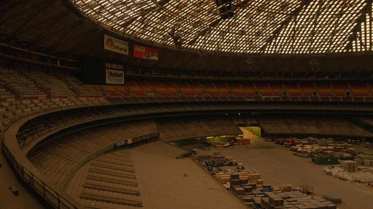 Empty abandoned stadium under dim lighting, illustrating worst nightu2019s sleep situations due to unusual places.