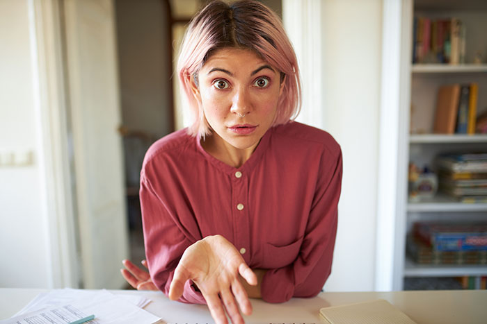 Woman with pink hair wearing a red shirt showing frustration, illustrating a lady going on a power trip at home. Woman with pink hair wearing a red shirt showing frustration, illustrating a lady going on a power trip at home.