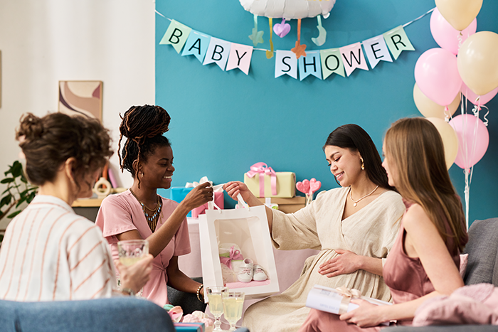 Woman at baby shower showing engagement ring while holding baby gift, cousin's family accusing her of stealing spotlight. Woman at baby shower showing engagement ring while holding baby gift, cousin's family accusing her of stealing spotlight.