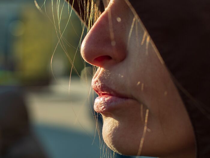 Close-up of a person's face in shadow, illustrating the dark impact of internet rabbit holes on people's lives.